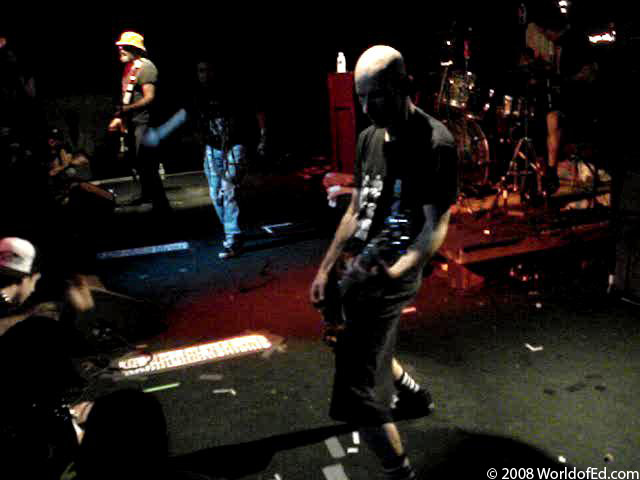 The Circle Jerks on stage performing.